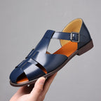 ZOFIA ATELIER navy blue PU leather woven casual sandals with buckle strap and rubber sole.