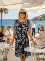 ZOFIA ATELIER navy blue chiffon dress with white floral print, A-line skirt, high waist, and short sleeves.