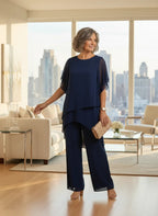 ZOFIA ATELIER navy blue chiffon suit set with quarter sleeves and wide-leg trousers, worn by a woman indoors.