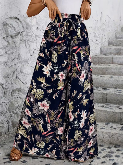ZOFIA ATELIER navy wide-leg trousers with a tropical floral print and drawstring waist. Polyester.