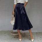 ZOFIA ATELIER navy blue satin mid-length skirt with a slight stretch and flowy silhouette.