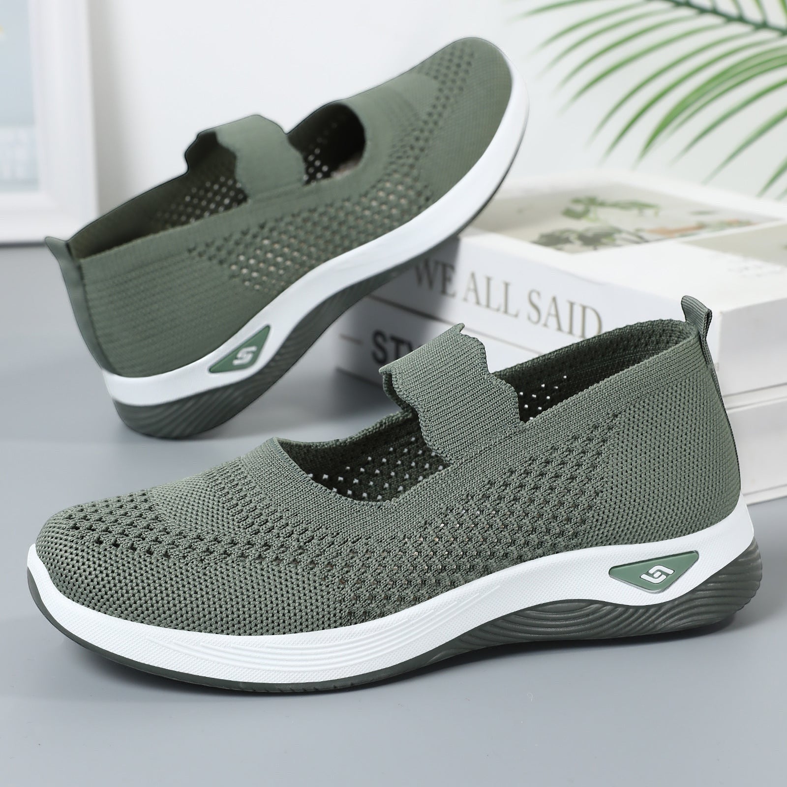 ZOFIA ATELIER olive green knit slip-on walking shoes with white soles and a low heel.