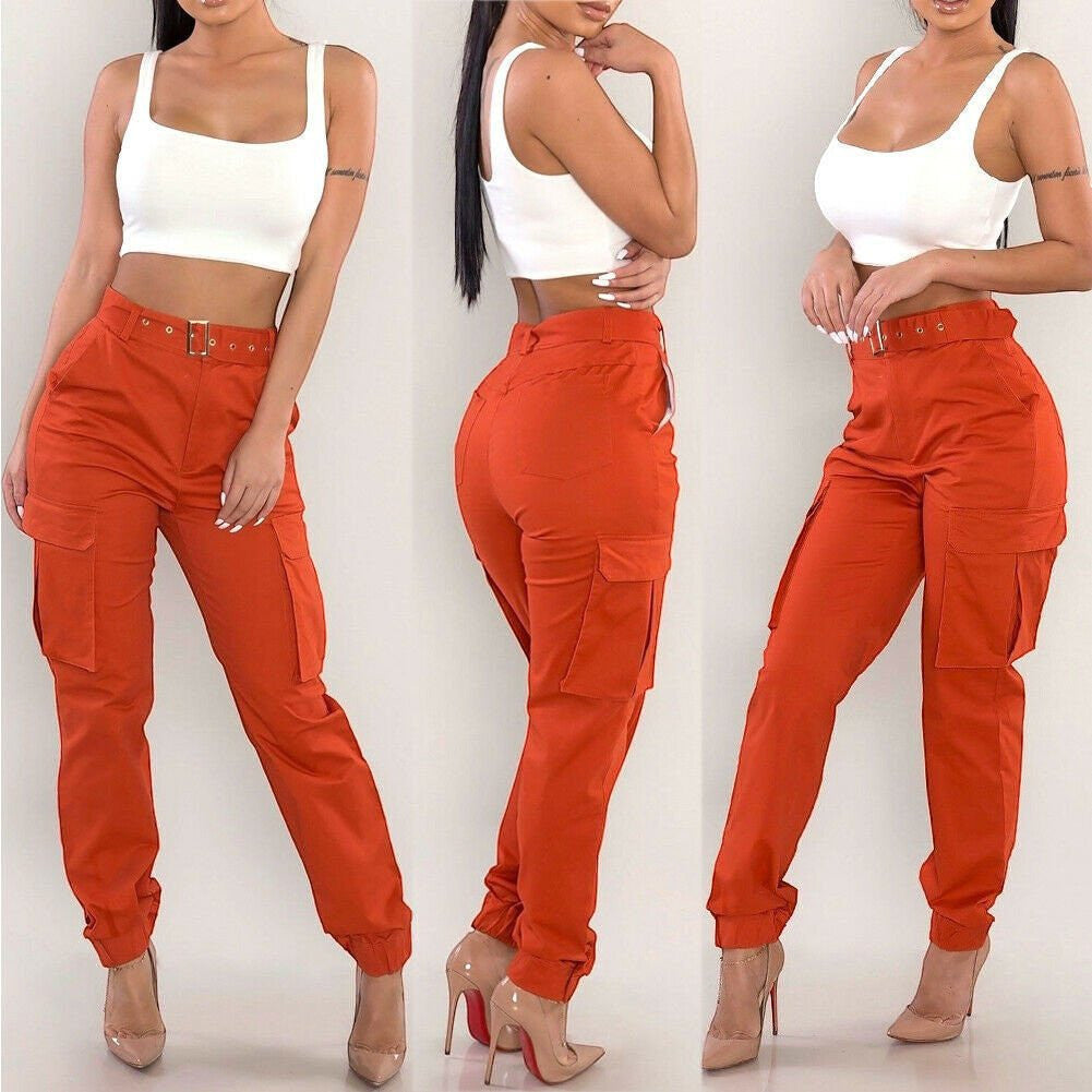 ZOFIA ATELIER orange slim-fit cargo overalls with high waist and zipper detail, paired with a white crop top.