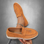 ZOFIA ATELIER orange suede slip-on loafers with tassel detail and flexible driving sole.
