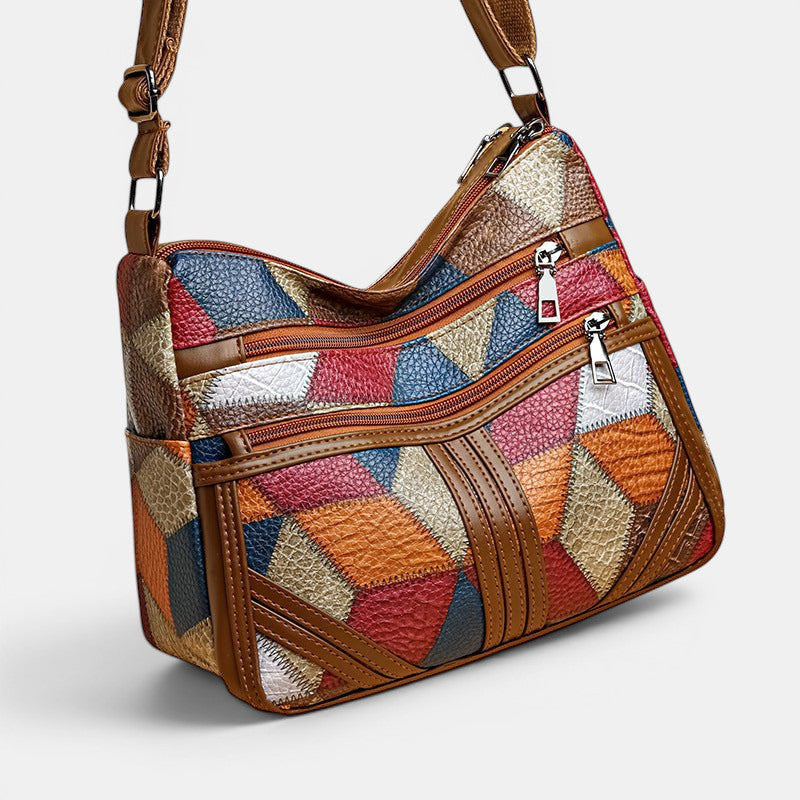 ZOFIA ATELIER ANIA multi-layer crossbody bag with patchwork design in brown, red, blue, and orange PU leather.