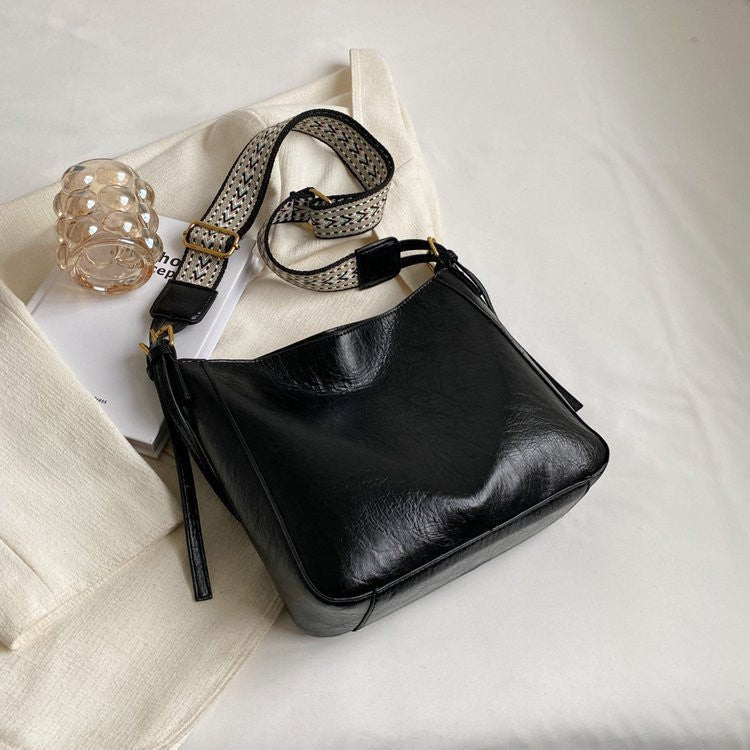 ZOFIA ATELIER PATRYCJA retro crossbody bag in black PU leather with a patterned strap.
