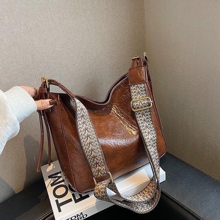ZOFIA ATELIER PATRYCJA retro crossbody bag in brown PU leather with a patterned strap and gold hardware.
