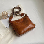 ZOFIA ATELIER PATRYCJA retro crossbody bag in brown PU leather with a patterned strap and gold zipper.