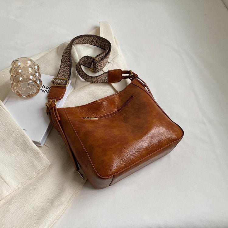 ZOFIA ATELIER PATRYCJA retro crossbody bag in brown PU leather with a patterned strap and gold zipper.