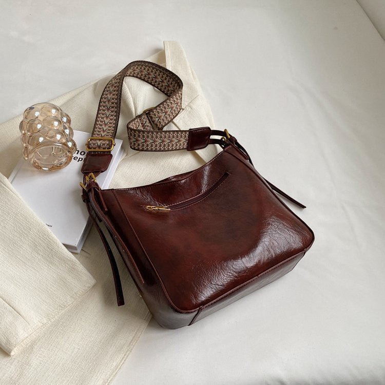 ZOFIA ATELIER PATRYCJA retro crossbody bag in dark brown PU leather with a patterned strap.