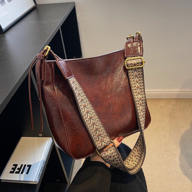 ZOFIA ATELIER PATRYCJA retro crossbody bag in reddish brown PU leather with a patterned strap.