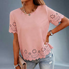 ZOFIA ATELIER pink polyester t-shirt top with crew neck, short sleeves, and embroidered hollow-out floral details on sleeves and hem.