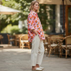ZOFIA ATELIER pink linen shirt with orange print, 3/4 sleeves, and relaxed fit. Model wears white pants.
