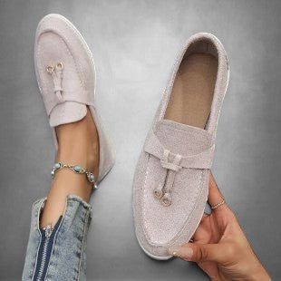 ZOFIA ATELIER light pink suede loafers with tassel detail and bow accent. Comfortable slip-on style.