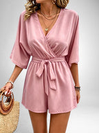 ZOFIA ATELIER pink V-neck polyester jumpsuit with short sleeves, tie waist, and cropped straight-leg shorts.