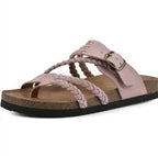 A single women's slide sandal with light pink braided straps, a matching pink adjustable strap with a metal buckle, a brown cork-look midsole, and a black outsole, shown on a plain white background.