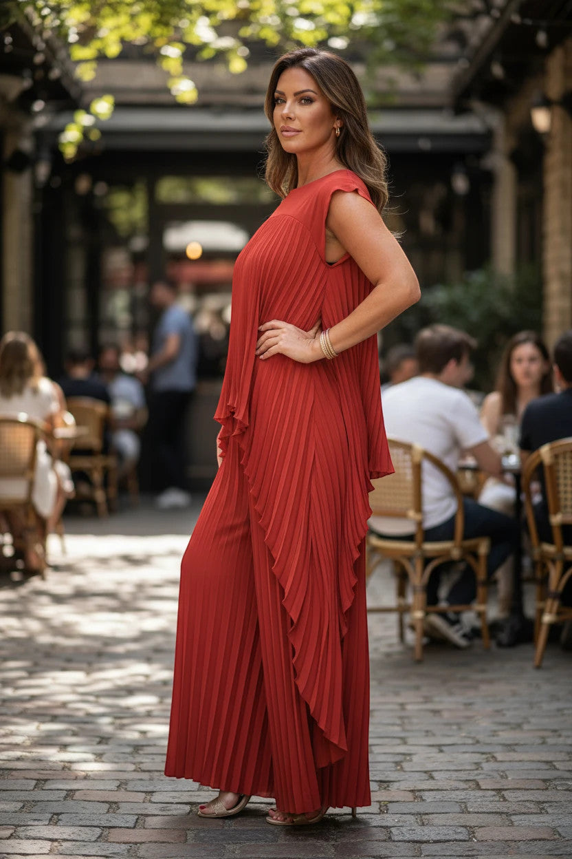 ZOFIA ATELIER pleated short sleeve suit in rust orange polyester, featuring wide-leg pants and a flowing tunic top.