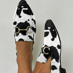 ZOFIA ATELIER Katarzyna pointed toe mules with cow print and gold horsebit detail.