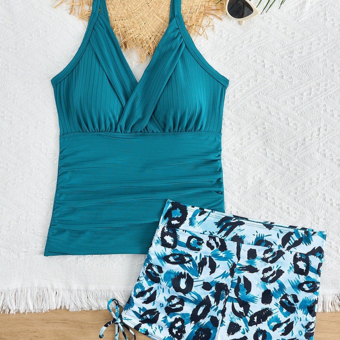 ZOFIA ATELIER Patrycja printed beach swim set in teal with boxer-style bottoms and a leopard print. Features a V-neck and ruched detailing.
