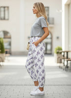 ZOFIA ATELIER white cotton linen pants with purple floral print, loose fit, casual style.