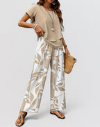 ZOFIA ATELIER beige top and white pants set with beige leaf print. Polyester. Three-quarter sleeves.