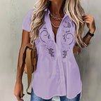 ZOFIA ATELIER light purple short-sleeved rayon and polyester blouse with embroidered hollow-out floral details.