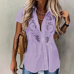 ZOFIA ATELIER light purple short-sleeved rayon and polyester blouse with embroidered hollow-out floral details.