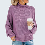 ZOFIA ATELIER Anna purple chunky knit turtleneck sweater with relaxed fit and long sleeves, holding a coffee cup.