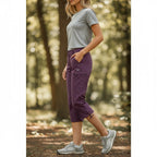 ZOFIA ATELIER purple seven-quarter waterproof hiking pants with zippered pockets and adjustable hem.