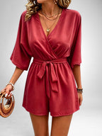 ZOFIA ATELIER Isabella V-neck red polyester short jumpsuit with tie waist and dolman sleeves.
