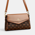 ZOFIA ATELIER Renata crossbody bag in brown PU with patchwork stitching and monogram print. Horizontal rectangular shape.