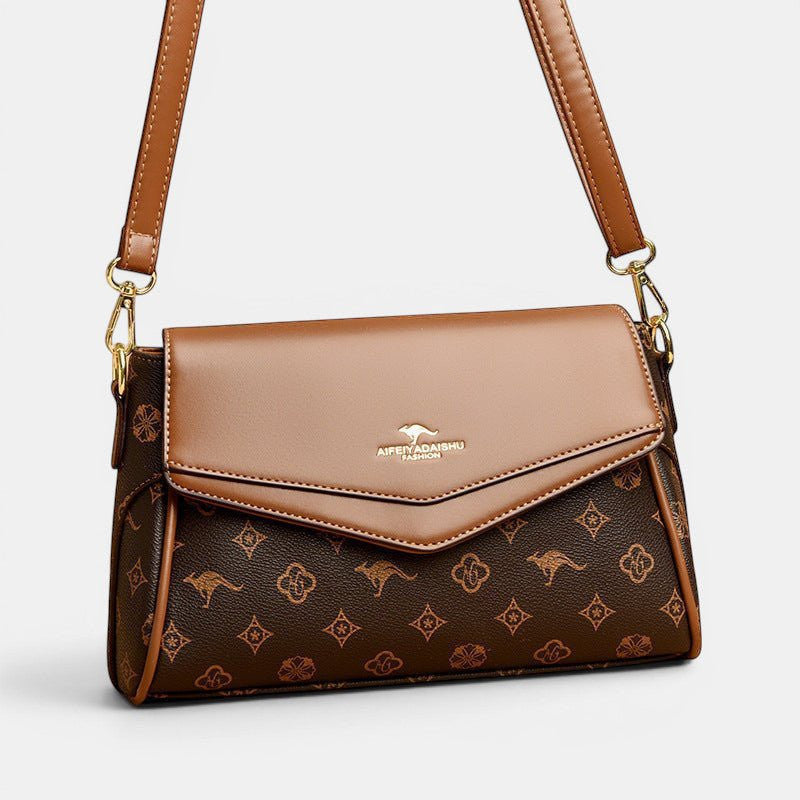 ZOFIA ATELIER Renata crossbody bag in brown PU with patchwork stitching and monogram print. Horizontal rectangular shape.