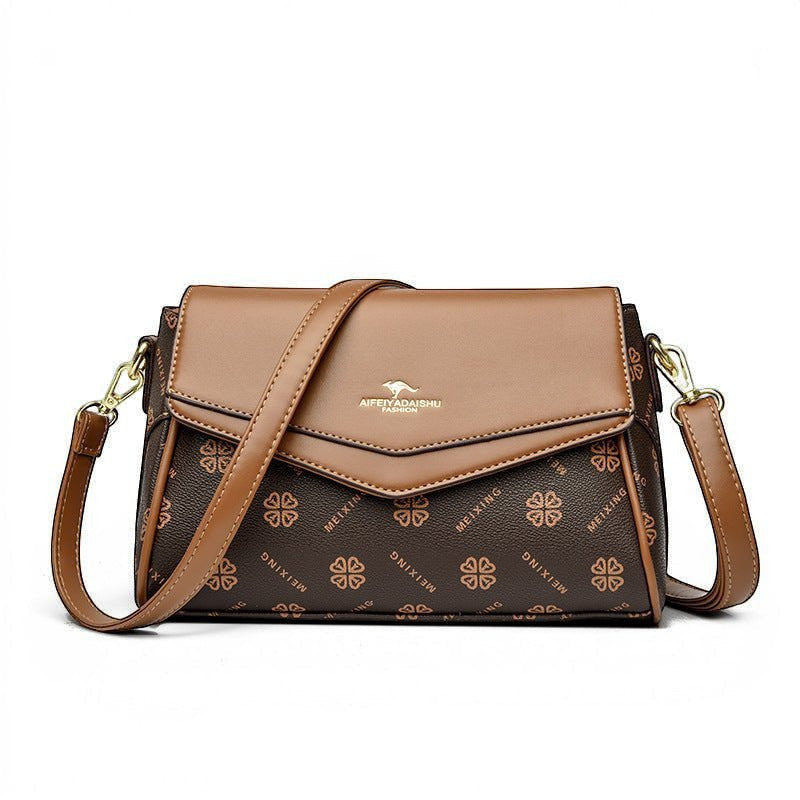 ZOFIA ATELIER Renata crossbody bag in brown PU with patchwork stitching and logo detail. Horizontal rectangular shape.
