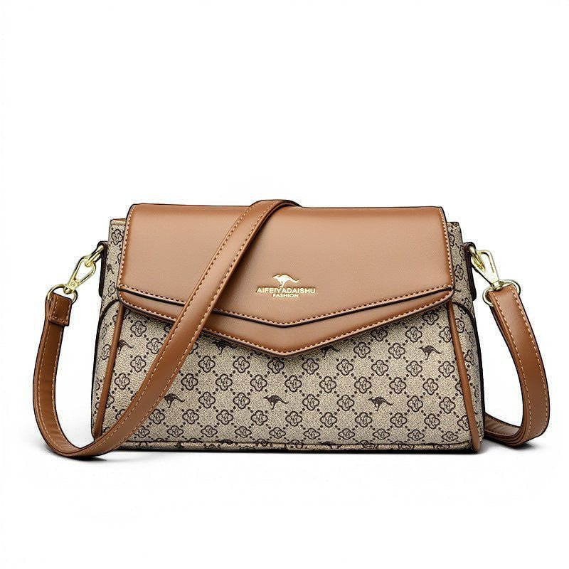 ZOFIA ATELIER Renata crossbody bag in brown PU with patchwork stitching and monogram pattern. Horizontal rectangular shape.