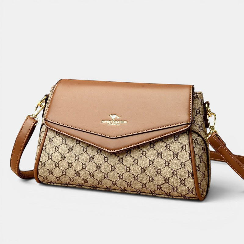 ZOFIA ATELIER Renata crossbody bag in brown PU with patchwork stitching and horizontal rectangular shape.