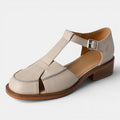 ZOFIA ATELIER creamy-white leather retro flat sandals with T-strap and buckle closure.