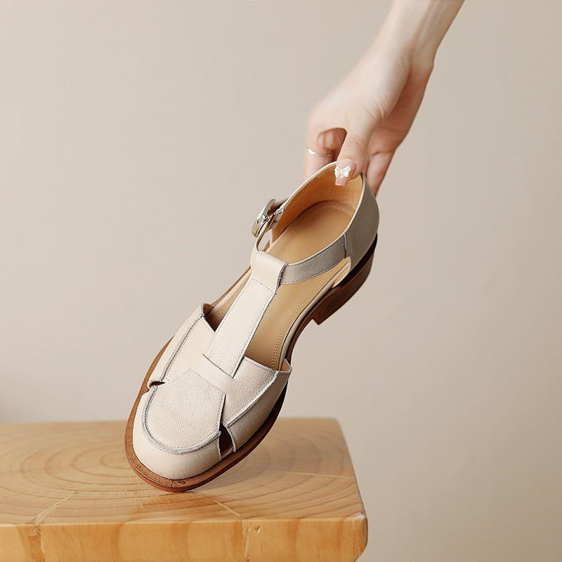 ZOFIA ATELIER creamy-white leather retro flat sandals with buckle strap and round toe.