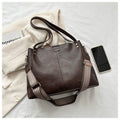 ZOFIA ATELIER Ilona retro tote bag in dark brown PU leather with a patterned strap. Features a single strap and a phone pocket.