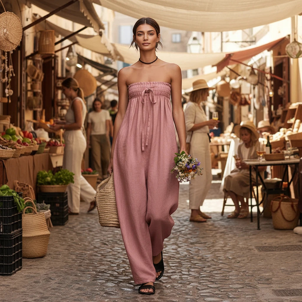 ZOFIA ATELIER dusty rose ruched strapless wide-leg jumpsuit with tie detail, worn by a model in a European market.