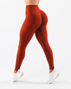 ZOFIA ATELIER rust orange seamless jacquard yoga pants with buttock lifting and body shaping features.