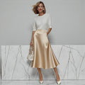 ZOFIA ATELIER satin midi skirt in champagne with a slight stretch fit and A-line silhouette.
