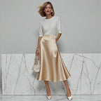 ZOFIA ATELIER satin midi skirt in champagne with a slight stretch fit and A-line silhouette.