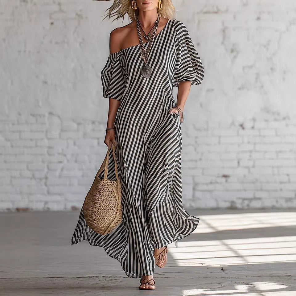 ZOFIA ATELIER SOFIA off-shoulder maxi dress in black and white stripes, made of polyester. Features short sleeves and a flowing silhouette.