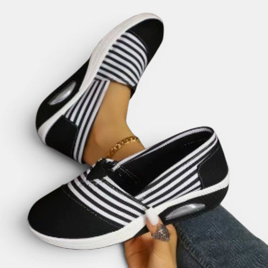 ZOFIA ATELIER black and white striped canvas slip-on shoes with a shallow mouth and rubber sole.