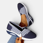 ZOFIA ATELIER navy and white striped canvas slip-on shoes with a shallow mouth and rubber sole.
