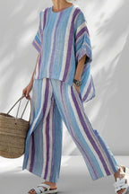ZOFIA ATELIER BARBARA striped lounge set with wide-leg pants and relaxed-fit top in blue, purple, and white.