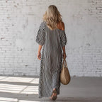 ZOFIA ATELIER black and white striped off-shoulder maxi dress with short sleeves and flowing polyester fabric.