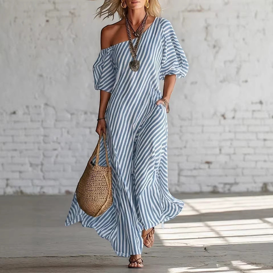 ZOFIA ATELIER blue and white striped off-shoulder maxi dress made of polyester with short sleeves and pockets.