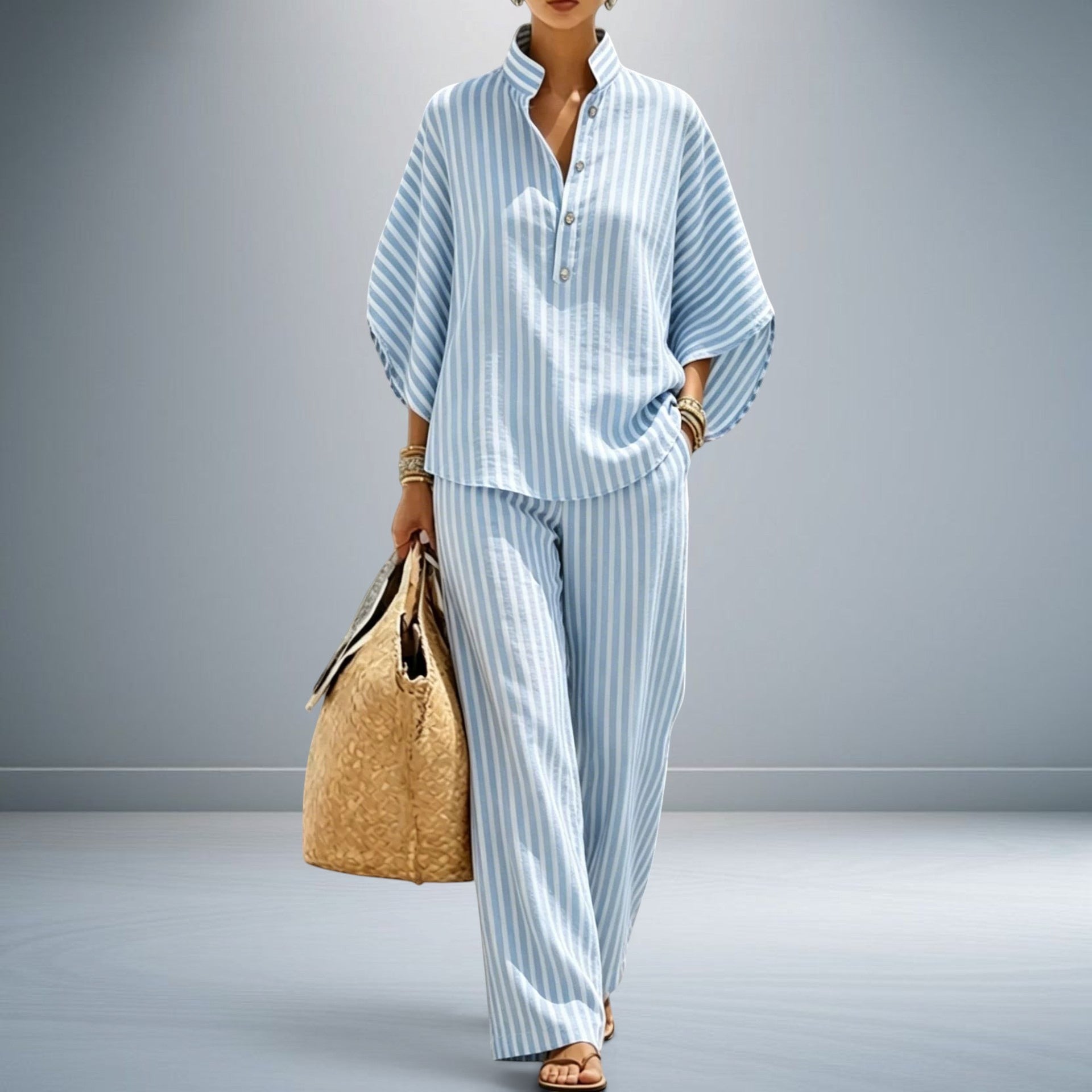 ZOFIA ATELIER light blue and white striped polyester shirt with three-quarter sleeves and matching full-length pants.