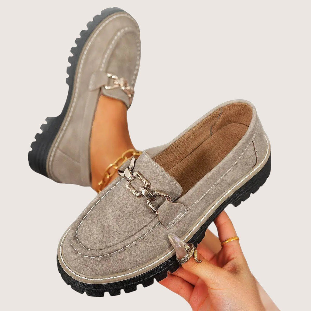 ZOFIA ATELIER taupe suede chunky platform loafers with gold chain detail and white stitching.